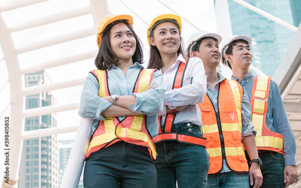Portrait of engineering group standing near buildings. Construction Concept. Portrait of engineering group standing near buildings. Construction Concept.