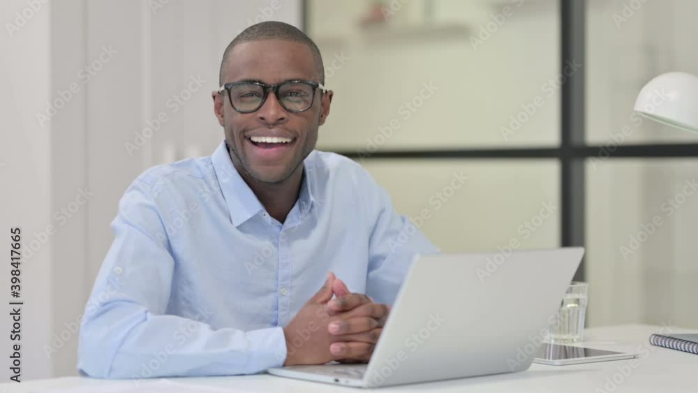 African Man with Laptop Smiling at Camera African Man with Laptop Smiling at Camera