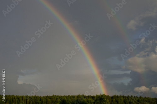 Colorful rainbow over cloudy sky wooden fence background