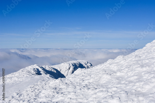 Winter mountain. Snowy peak high  above the clouds. Show and clouds on Dry Mountain, Serbia © Ivan