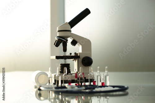 Stethoscope ampoule pill microscope on glass table
