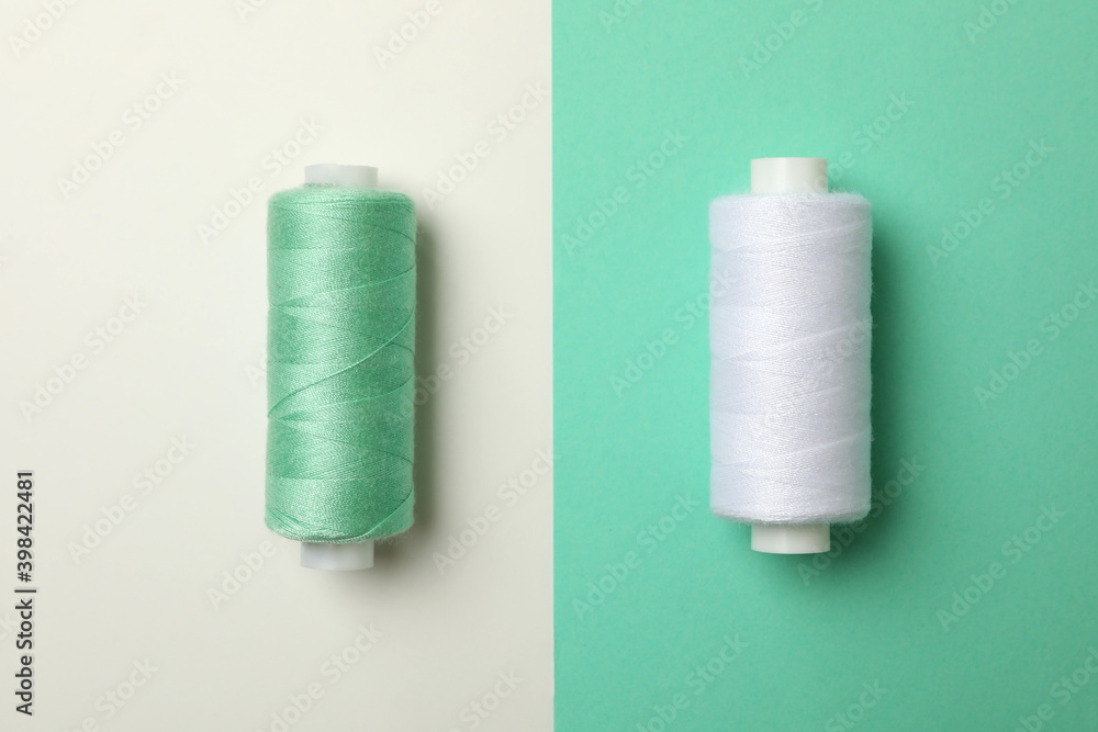 Sewing thread on two tone background, close up Sewing thread on two tone background, close up