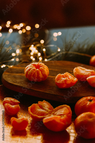 tangerines on the background of Christmas lights