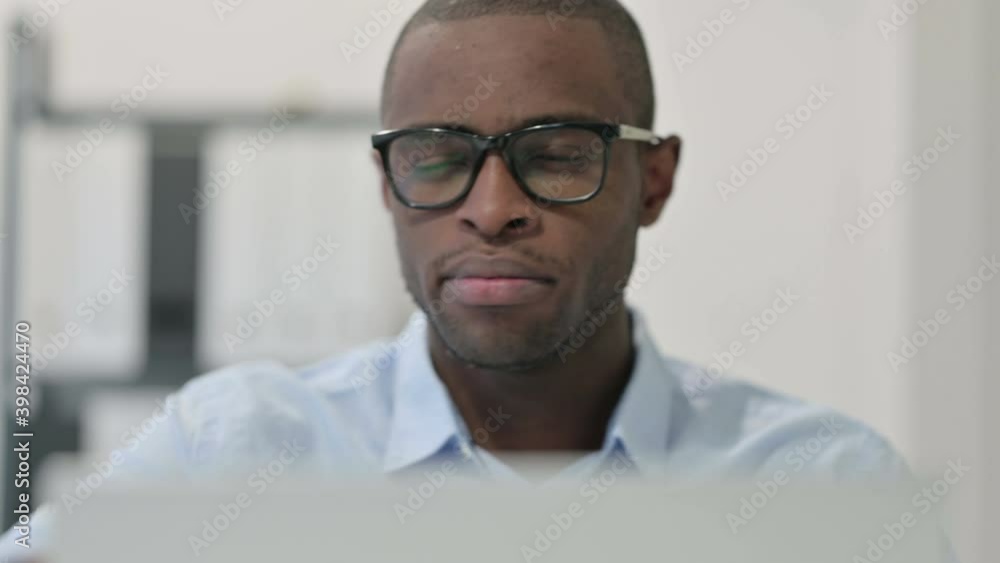 Close Up of African Man Doing Thumbs Down with Laptop Close Up of African Man Doing Thumbs Down with Laptop