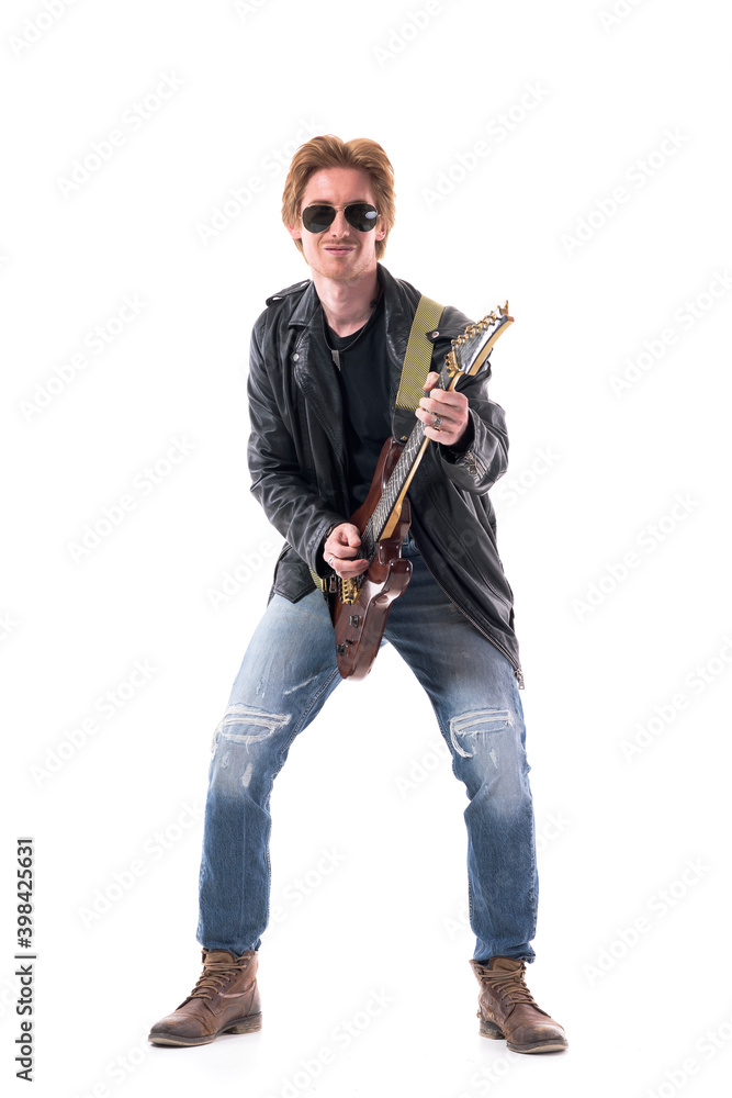Cool smiling confident young guitarist playing rock music on electric guitar. Full body length isolated on white background. 