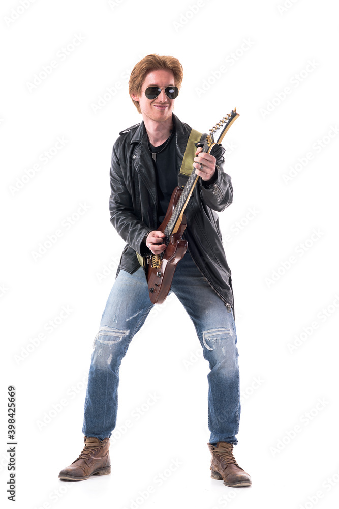 Happy passionate skillful rock guitarist playing electric guitar having fun. Full body length isolated on white background. Happy passionate skillful rock guitarist playing electric guitar having fun. Full body length isolated on white background.
