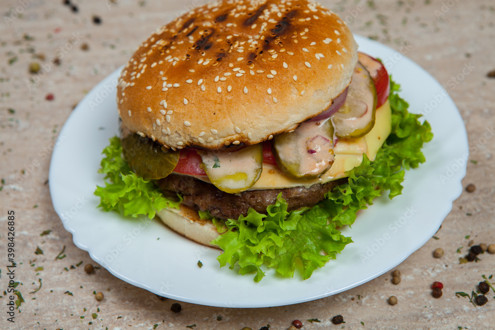 Fresh and juicy hamburger. Delicious cheese burger on a rustic wooden table Fresh and juicy hamburger. Delicious cheese burger on a rustic wooden table