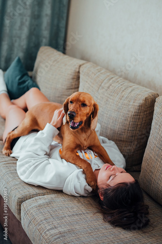 Dog lying on the couch with a woman