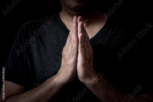 A man praying hands pay respect to sacred things.