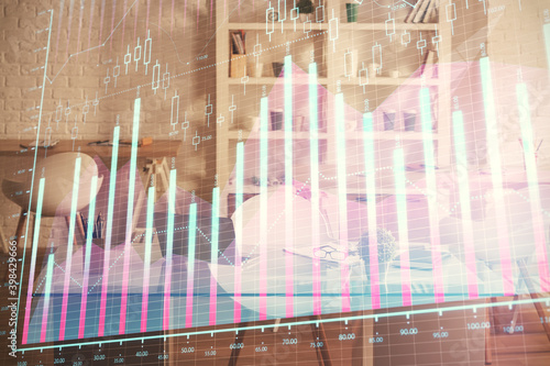 Double exposure of financial graph drawing and office interior background. Concept of stock market.