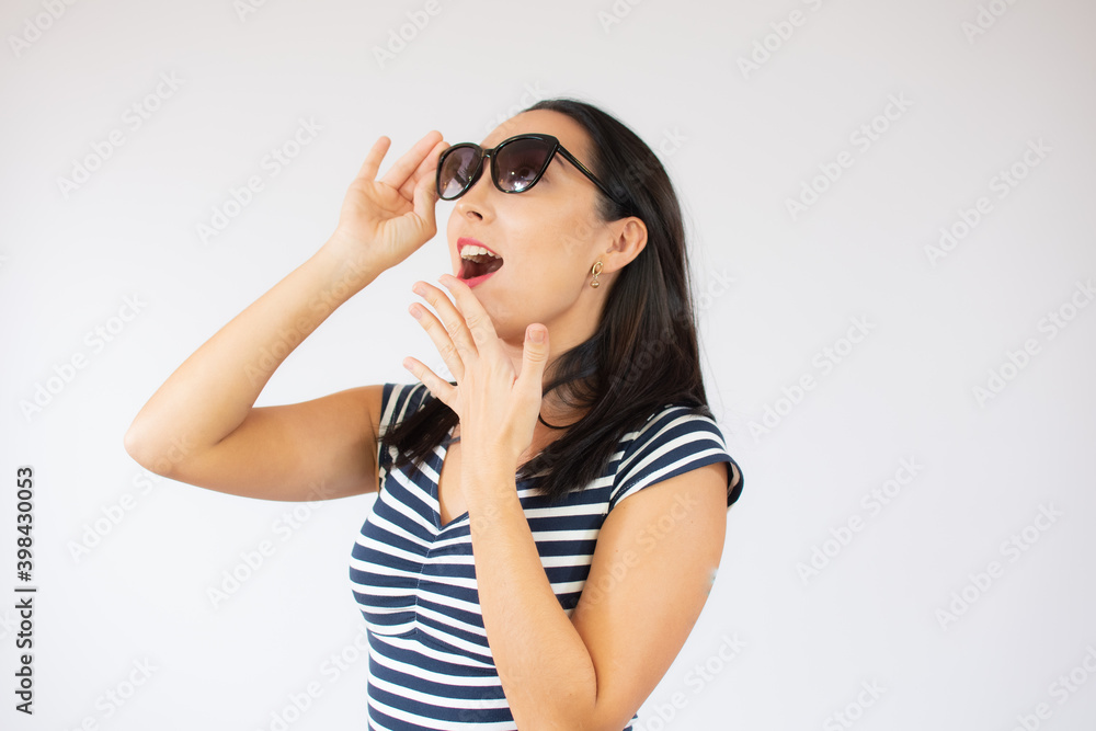 Fashion portrait of young excited woman wearing striped t-shirt over white background. Fashion portrait of young excited woman wearing striped t-shirt over white background.