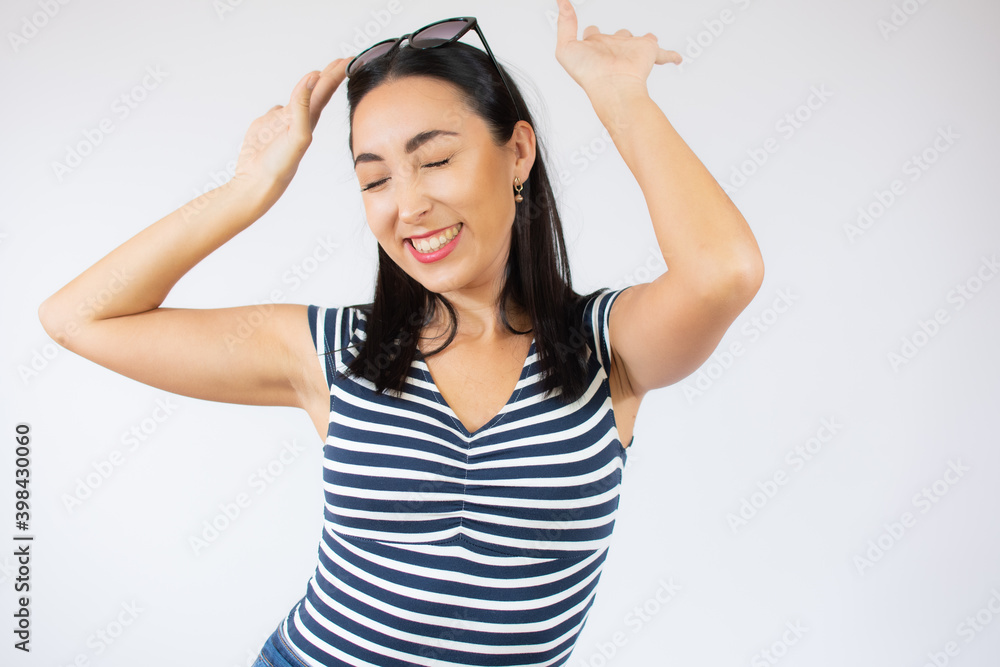 Fashion portrait of young happy woman wearing striped t-shirt over white background. Fashion portrait of young happy woman wearing striped t-shirt over white background.