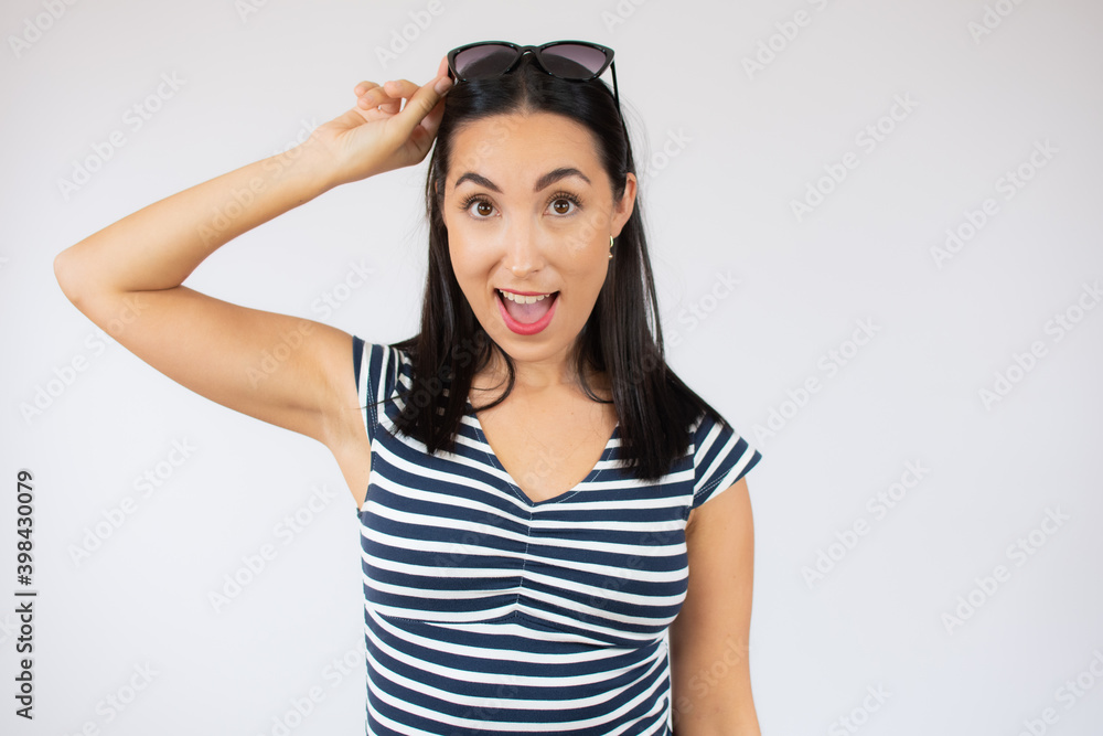 Fashion portrait of young woman wearing striped t-shirt over white background. Fashion portrait of young woman wearing striped t-shirt over white background.
