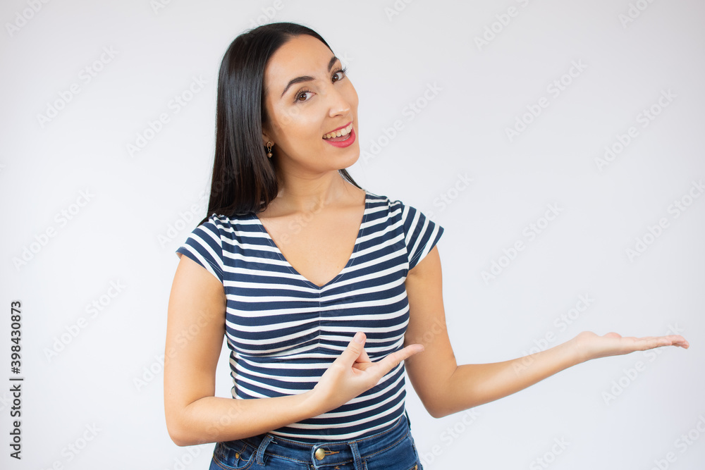 Young woman in striped t-shirt over isolated white background pointing finger to the side Young woman in striped t-shirt over isolated white background pointing finger to the side