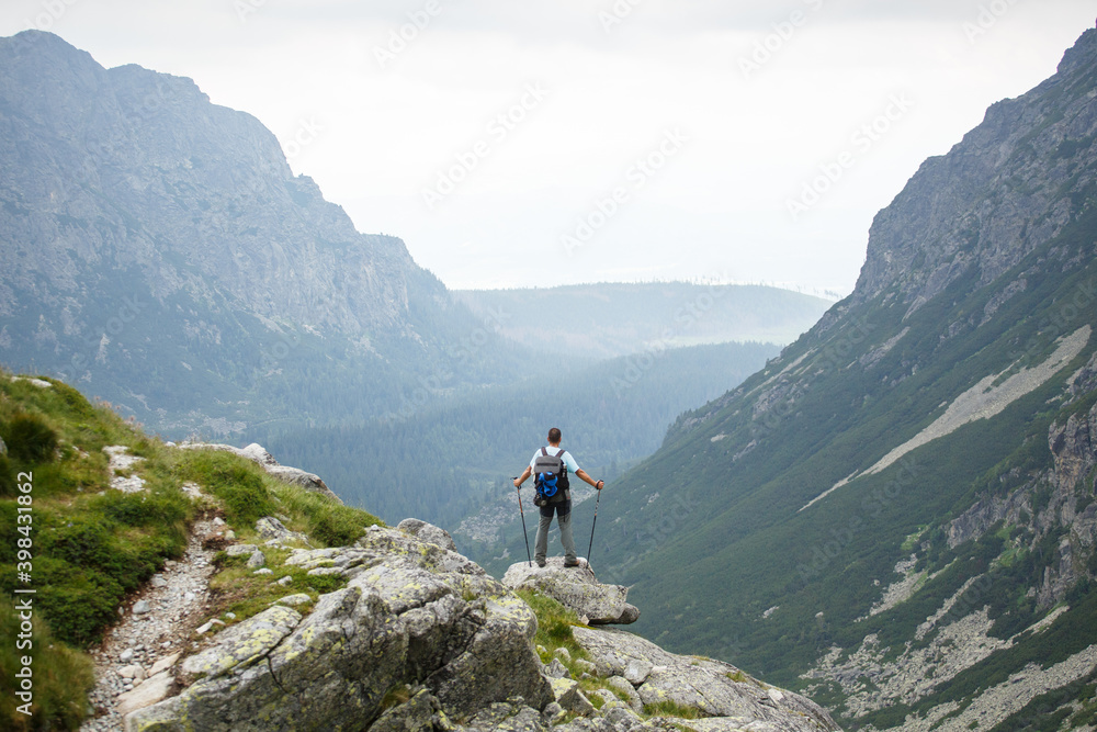 Hiker at the top of a rock with backpack