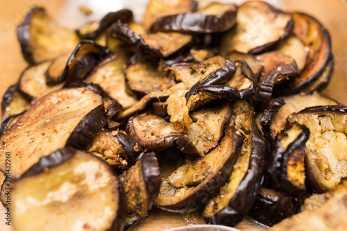 Close up of pile of slices of roasted cooked spicy eggplant