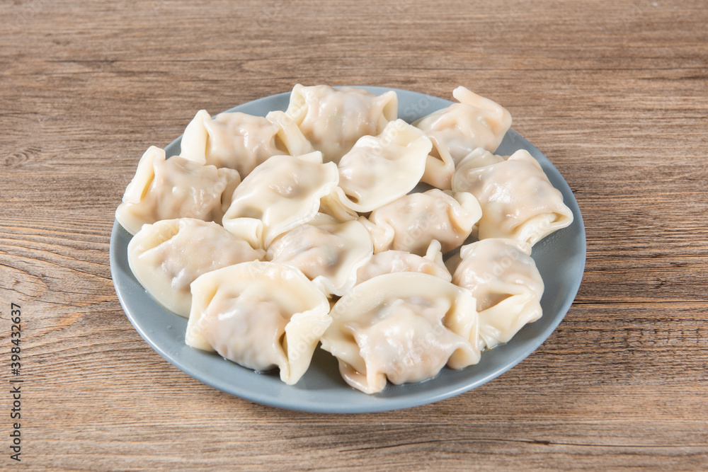 Close up fresh boiled dumplings. Chinese food on rustic old vintage wooden background