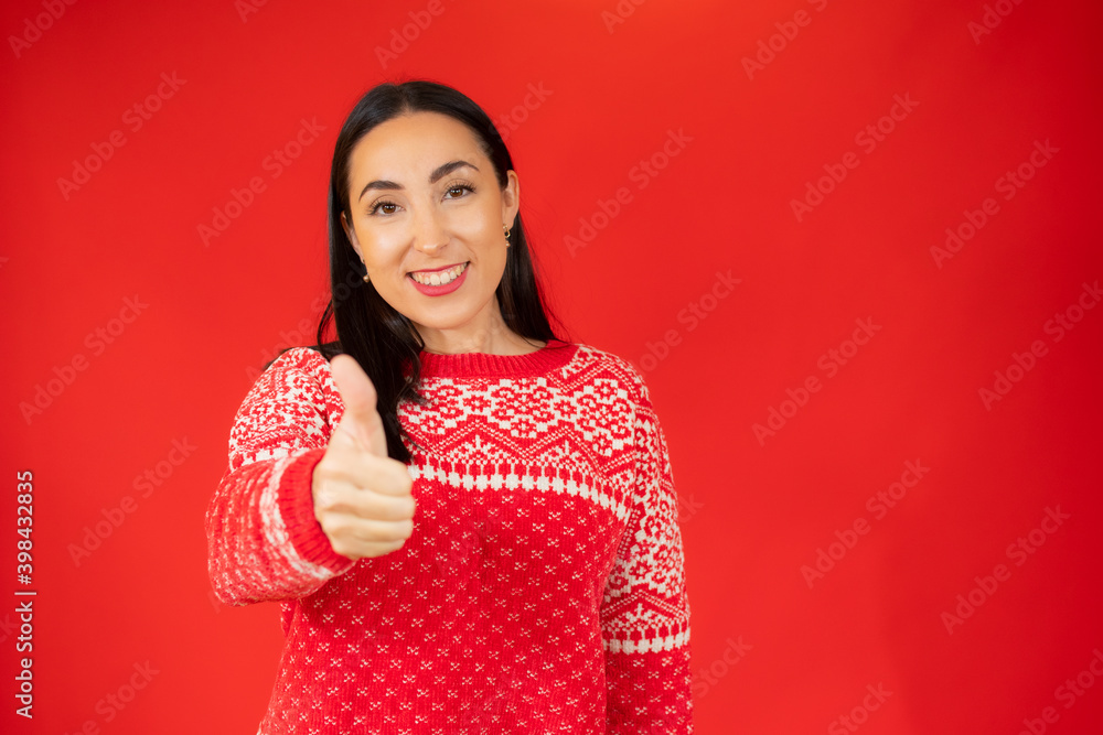 Young happy cheerful woman showing thumb up over red background. Young happy cheerful woman showing thumb up over red background.
