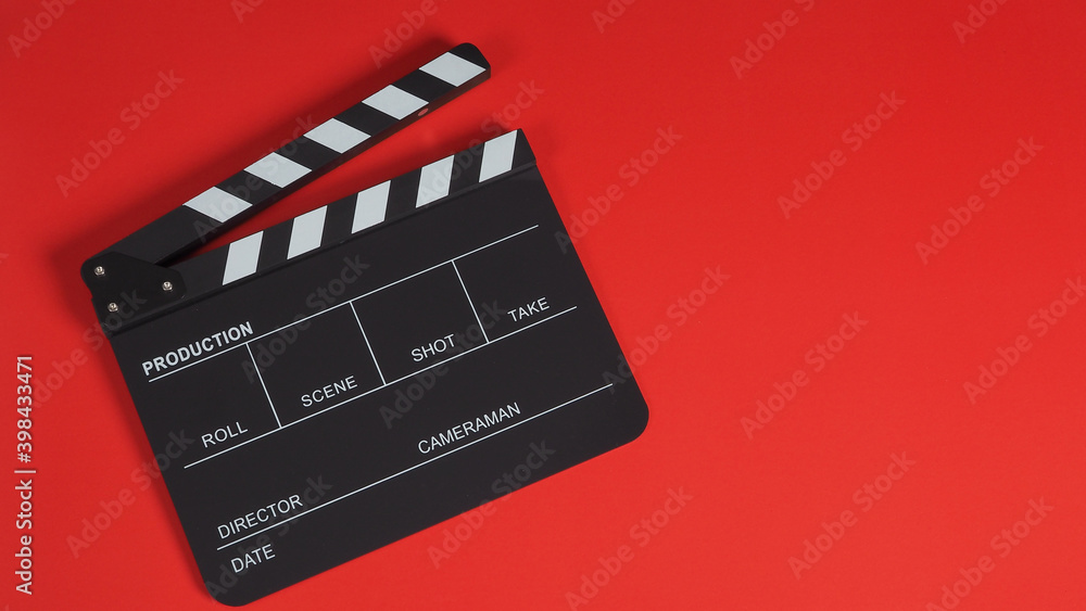 Black Clapperboard or Clapperboard or clap board or movie slate .It is use in video production ,film, cinema industry on red background.no people .