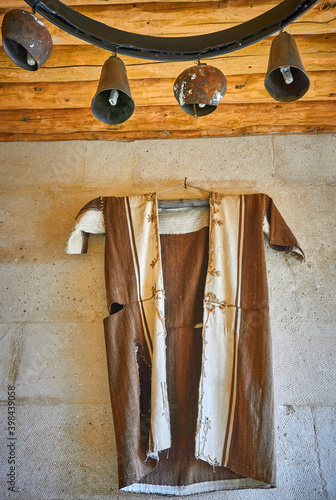 Traditional  and old  shepherd dress on the wall photo