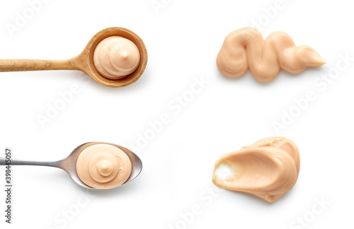 Set of pink mayonnaise tartar sauce in spoons top view isolated on white background