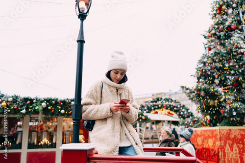 Focused woman browsing smartphone during walk