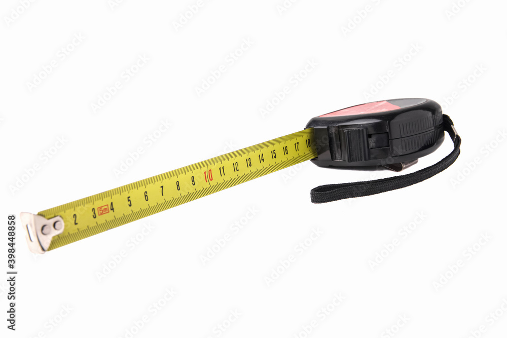 Construction tape measure in black, lying on its side with an open tape. Isolated on a white background. Close up Construction tape measure in black, lying on its side with an open tape. Isolated on a white background. Close up
