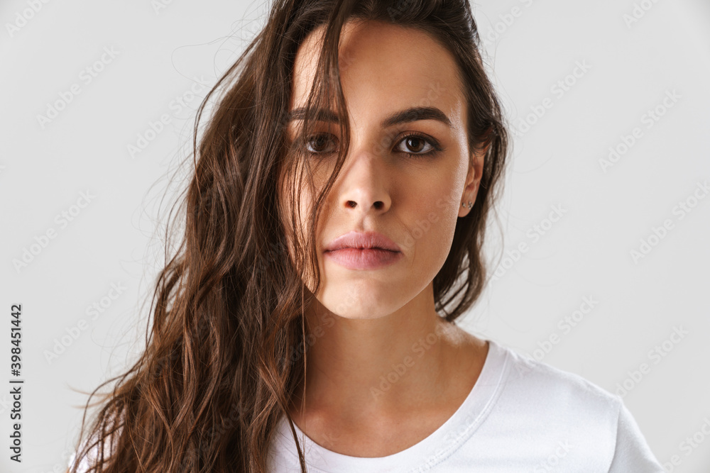 Pleased beautiful girl posing and looking at camera Pleased beautiful girl posing and looking at camera