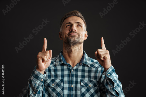 Serious grey-haired man pointing isolated