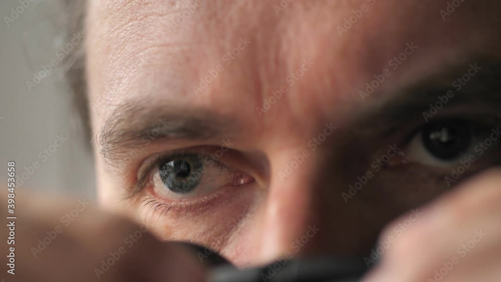 Surprised man with binoculars. Curious guy with big eyes. Silly funny