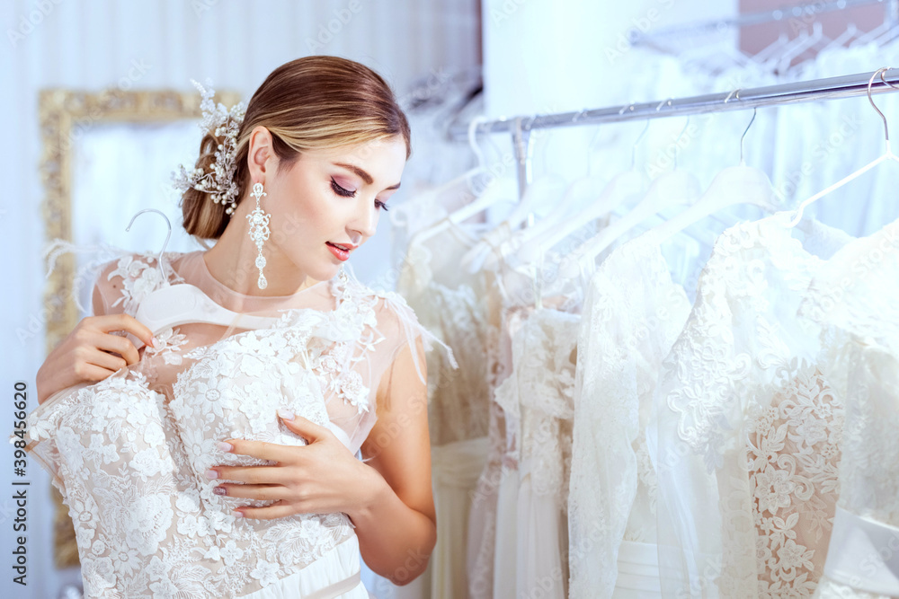 Beautiful woman chooses a wedding dress. Beautiful woman chooses a wedding dress.