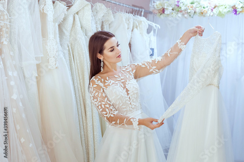 Beautiful bride tries on a wedding dress.