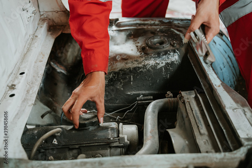 closeup photo of hand gesture of man check oil in the car