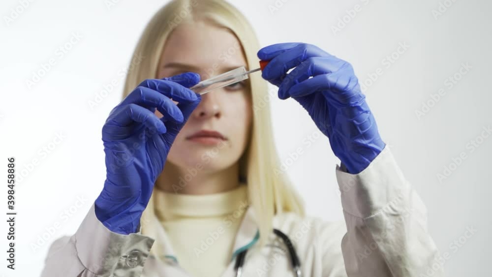 Pandemic Covid-19. Test from the nasopharynx for infection with coronavirus. Doctor on a white background holds a test tube Pandemic Covid-19. Test from the nasopharynx for infection with coronavirus. Doctor on a white background holds a test tube