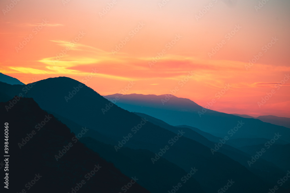 Sun setts over Caucasus Mountains. Joyful motivational bright colorful image. Georgia