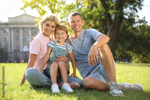 Wallpaper Mural Happy parents with their child having fun on green grass. Spending time in nature Torontodigital.ca