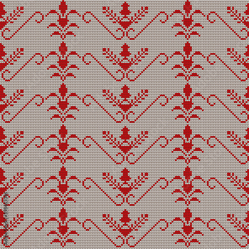 Knitted seamless pattern of fancy flowers in Greek style. White background with a red pattern. For design, decoration