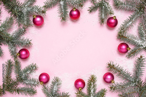 Christmas decorations and fir tree on pink background