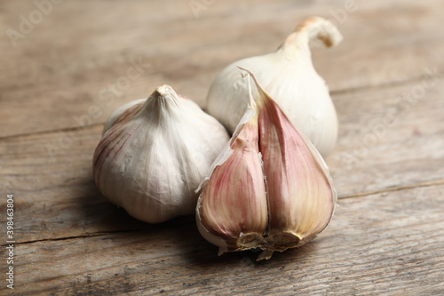 Fresh organic garlic on wooden table, closeup