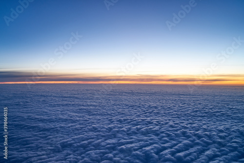 Evening sky just after sunset with a low layer of clouds as seen from an airplane