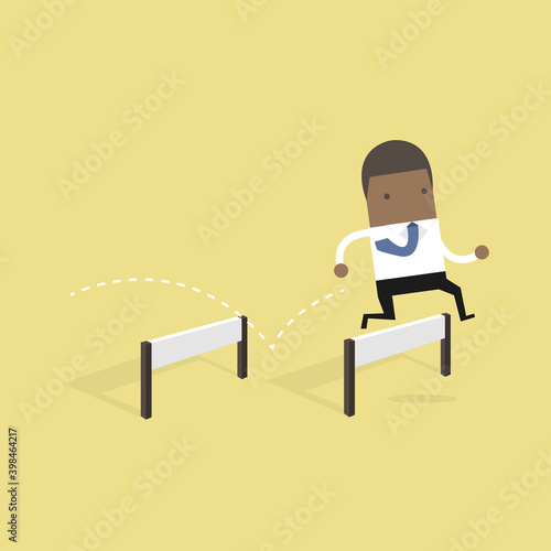 African businessman jumping over hurdle.