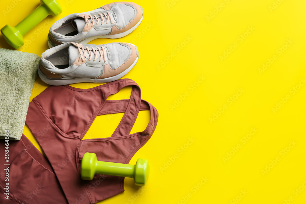 Fototapeta premium Flat lay composition with sportswear and equipment on yellow background, space for text. Gym workout