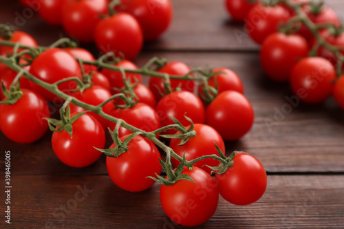 Fresh ripe cherry tomatoes on wooden table, closeup