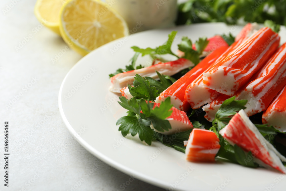 Crab sticks and parsley on light table, closeup Crab sticks and parsley on light table, closeup