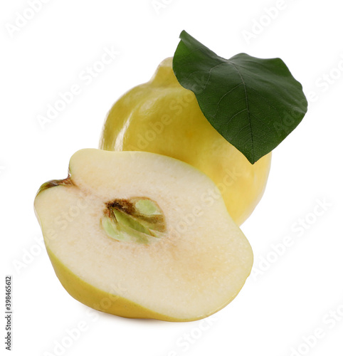 Whole and cut delicious quinces on white background