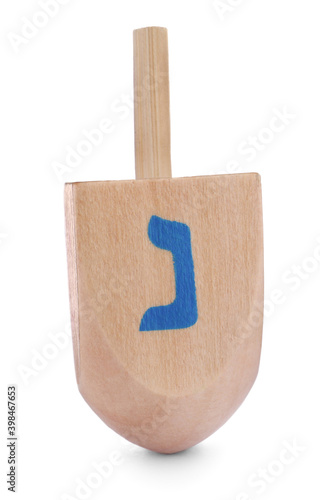 Wooden Hanukkah traditional dreidel with letter Nun isolated on white photo