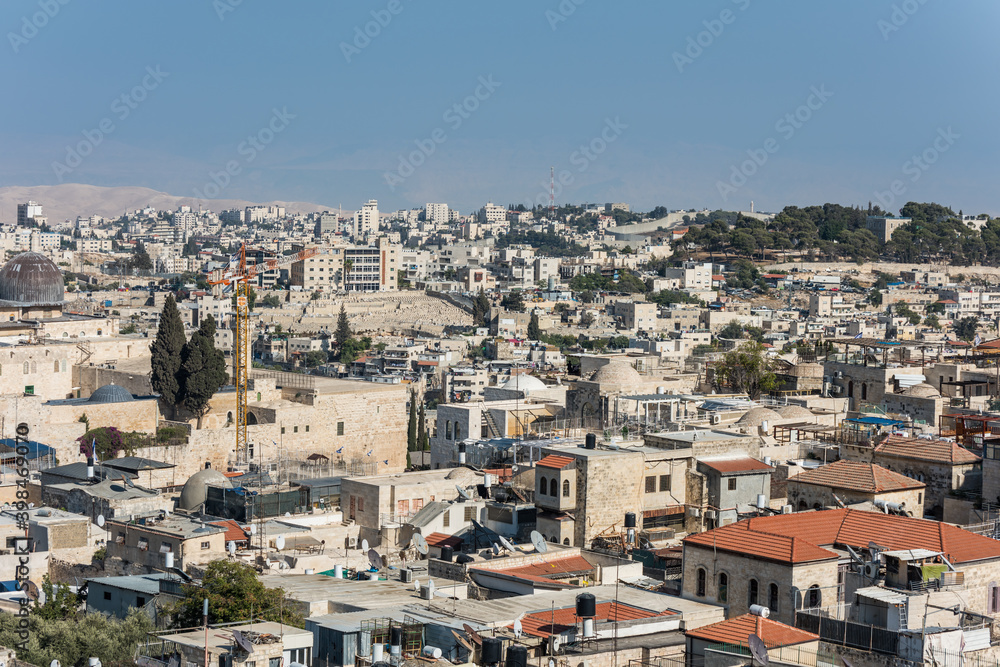 Aerial view of rooftops of the old city of Islamic quarter with blue sky of Jerusalem, with background of mosque of Al-Aqsa and Mount of Olives,  View from the Lutheran Church of the Redeemer.