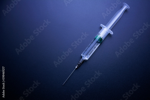 On dark blue background syringes. The concept of medicine and drug addiction
