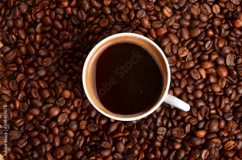 Coffee beans background with hot coffee mug