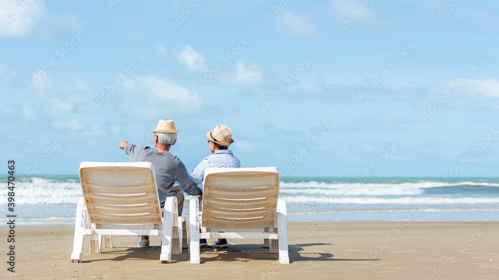 Asian Lifestyle senior couple hug and pointing on the beach happy in love romantic and relax time.  People tourism elderly family travel leisure and activity after retirement in vacations and summer.